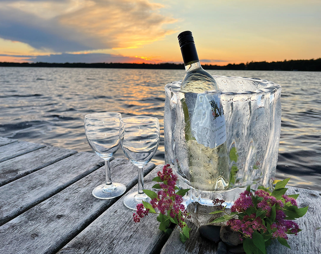 A fluted ice lantern used as a wine chiller on a beautiful summer night on the dock.